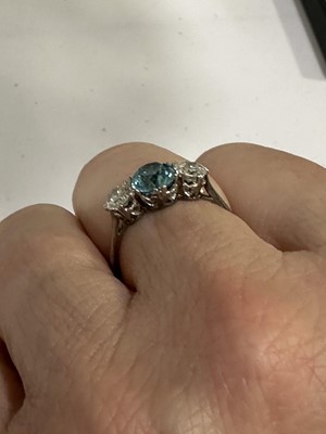 Lot 82 - A heat treated blue zircon and diamond three stone ring.