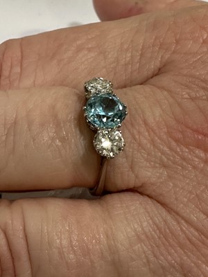 Lot 82 - A heat treated blue zircon and diamond three stone ring.