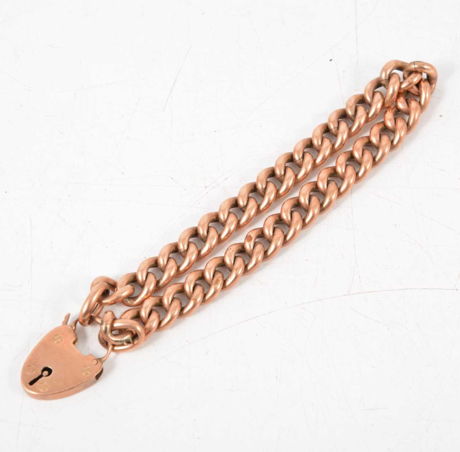 Lot 246 - A rose metal hollow curb link bracelet.