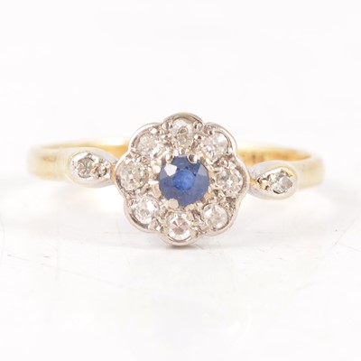 Lot 236 - A sapphire and diamond cluster ring.