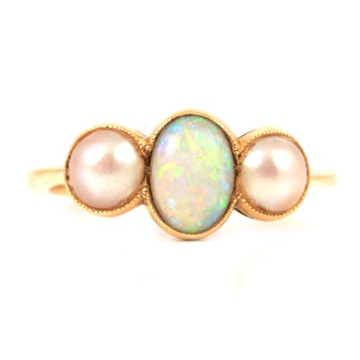 Lot 89 - An oval cabochon cut opal and pearl three stone ring.