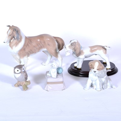 Lot 24 - Four Lladro dog figures, and another of an Owl