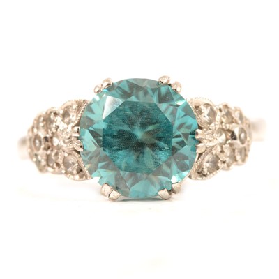 Lot 81 - A heat treated blue zircon and diamond ring.