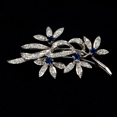 Lot 269 - A sapphire and diamond floral spray brooch.