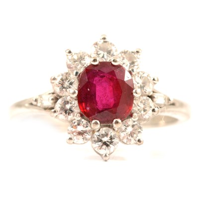 Lot 60 - A ruby and diamond cluster ring.