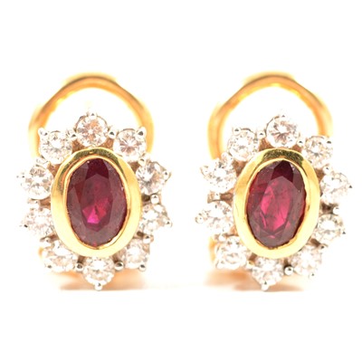 Lot 162 - A pair of ruby and diamond oval cluster earrings.