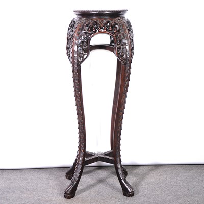 Lot 560 - A Chinese carved hardwood jardiniere stand