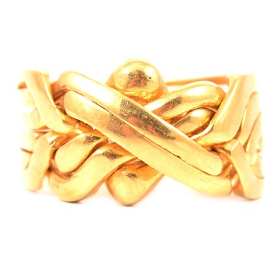 Lot 134 - A yellow metal puzzle ring.