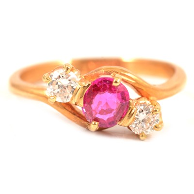 Lot 63 - A ruby and diamond three stone crossover ring.