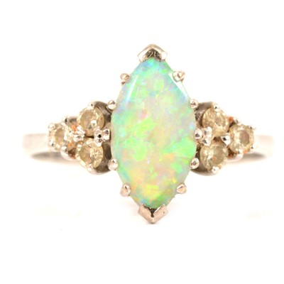 Lot 88 - A marquise opal and diamond ring.