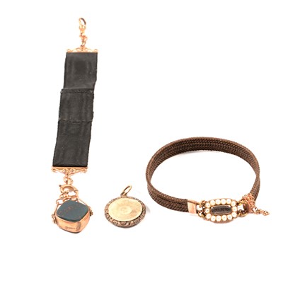 Lot 309 - A mourning bracelet made from hair with clasp, 9 carat gold fob and a small locket.