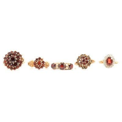 Lot 349 - Five 9 carat yellow gold garnet dress rings.