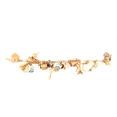Lot 177 - A yellow metal bracelet with gold and silver charms attached.