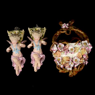 Lot 84 - Pair of Continental porcelain cherub wall pockets and one other