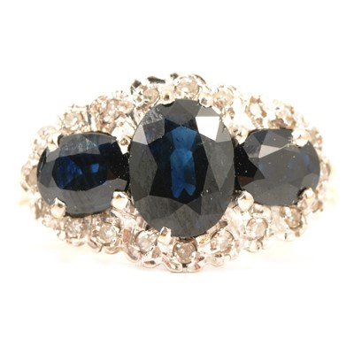 Lot 49 - A sapphire and diamond triple cluster ring.
