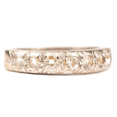 Lot 320 - A diamond half eternity ring.