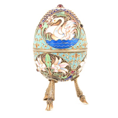 Lot 485 - 20th century Russian enamelled silver egg shaped trinket pot raised on three hoof legs.