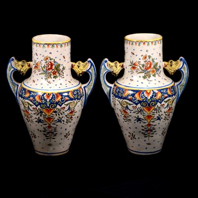 Lot 50 - A pair of twin-handled faience pottery vases