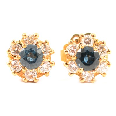 Lot 165 - A pair of sapphire and diamond circular cluster earrings.