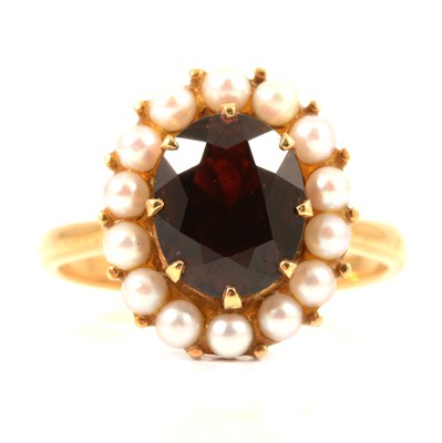 Lot 106 - A garnet and pearl oval cluster ring.