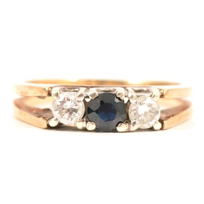 Lot 51 - A sapphire and diamond three stone ring.
