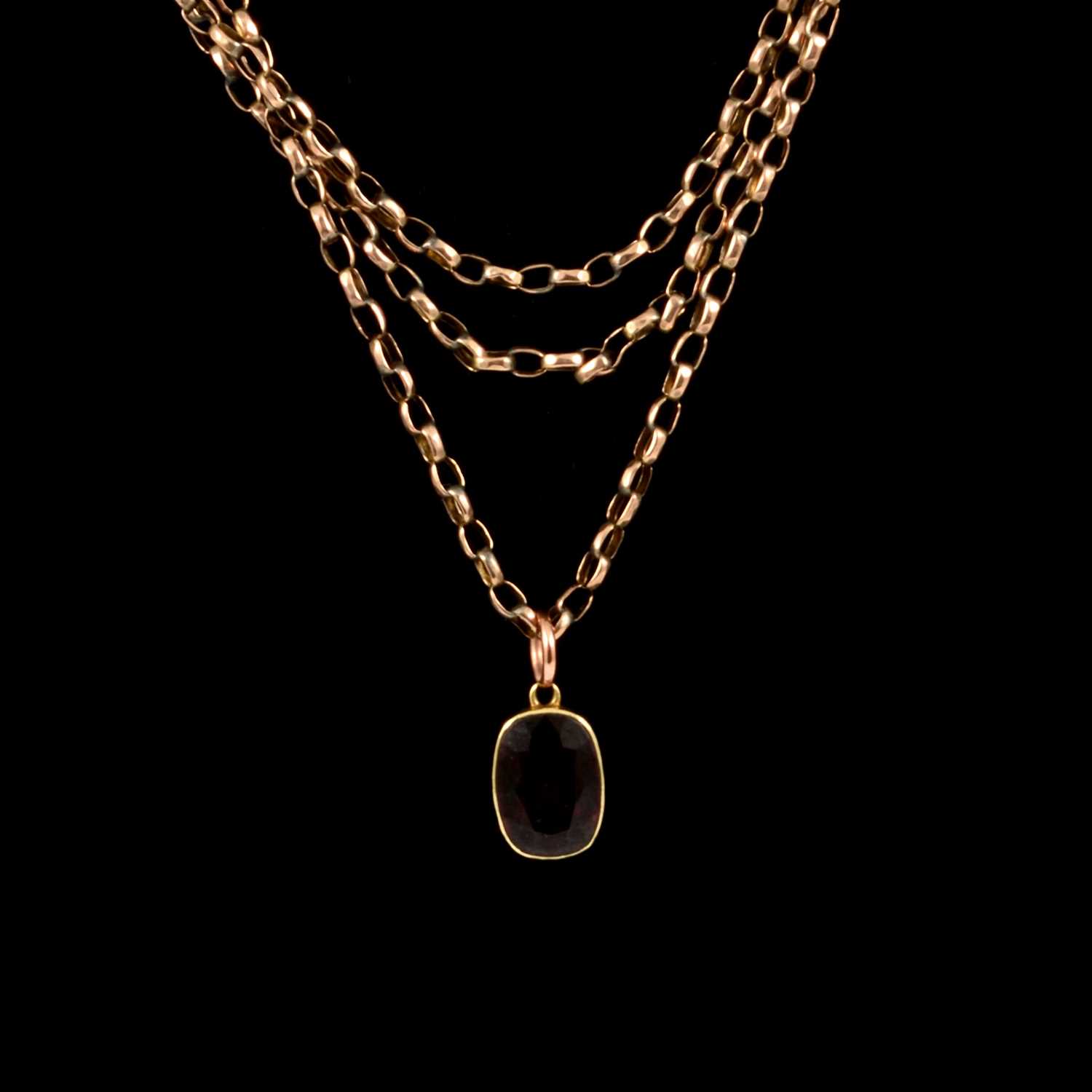 Lot 221 - A yellow metal guard chain with red stone pendant.