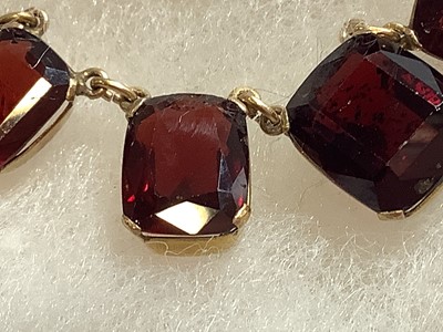 Lot 228 - A garnet necklace, two pairs of peridot earrings, coral pendant.