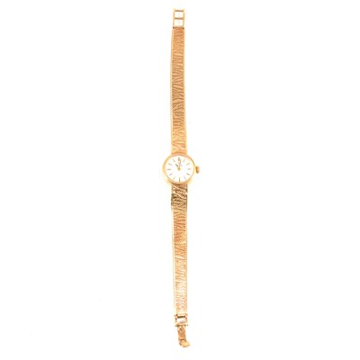 Lot 378 - Omega - a lady's 9 carat gold bracelet watch.