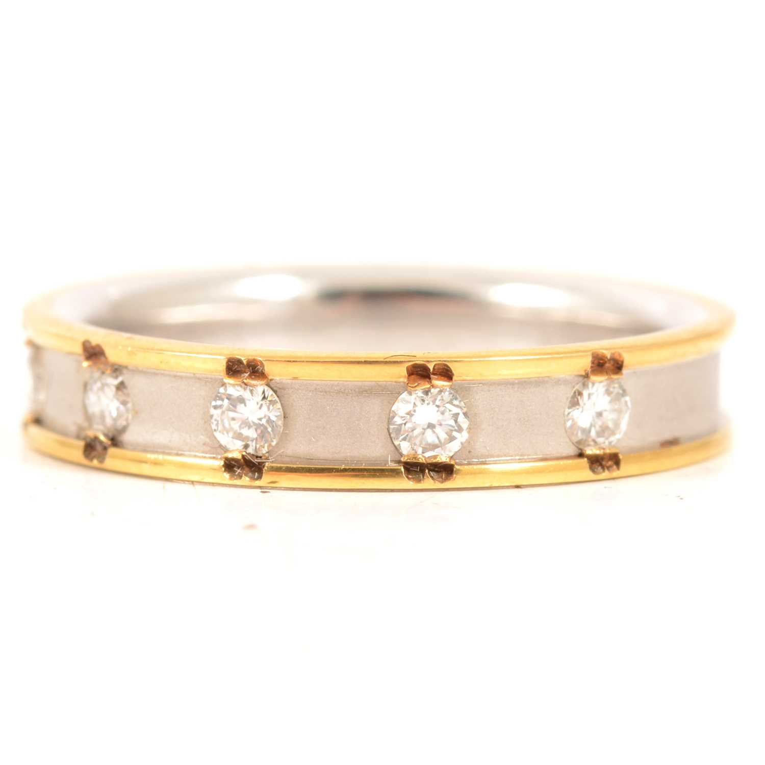 Lot 34 - A diamond set 18 carat yellow and white gold band.