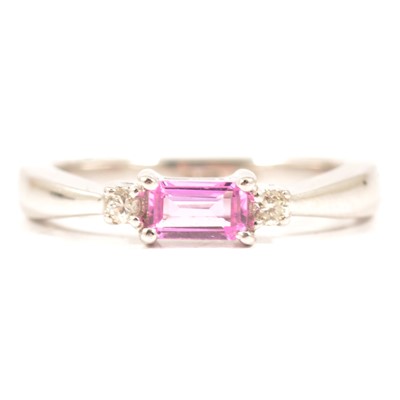 Lot 69 - A pink tourmaline and diamond three stone ring.