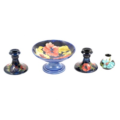 Lot 1 - Moorcroft Pottery - pair of Poppy pattern dwarf candlesticks, Hibiscus comport and miniature vase.