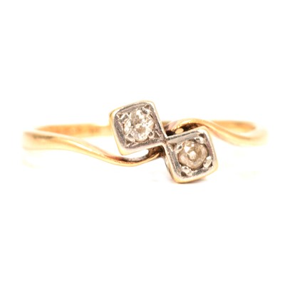 Lot 18 - A diamond two stone crossover ring.