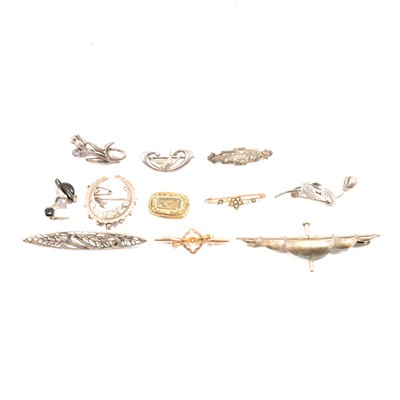 Lot 449 - A collection of Victorian and later silver and gold brooches.