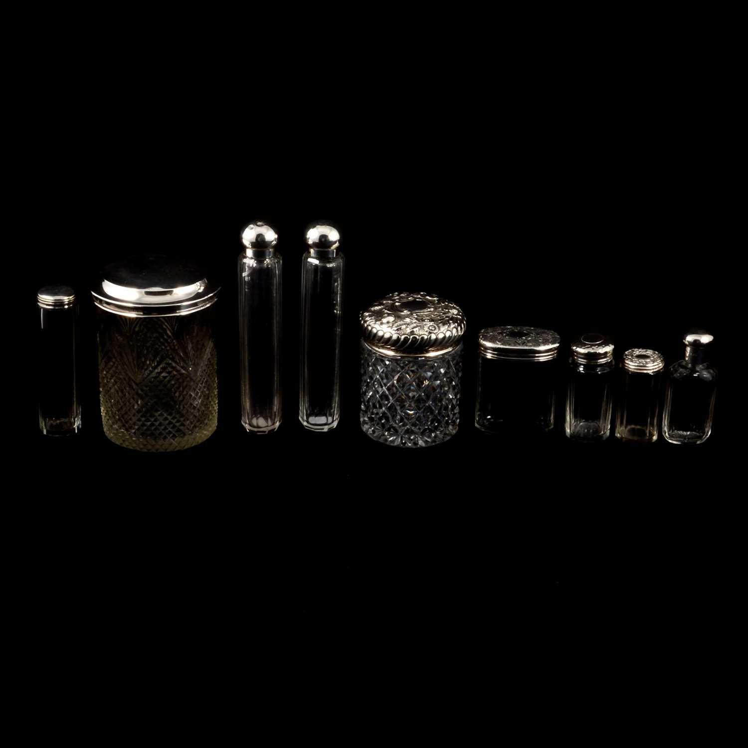 Lot 302 - Four large silver-topped glass jars, other silver jars and bottles.