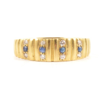 Lot 48 - A contemporary sapphire and diamond half hoop ring.