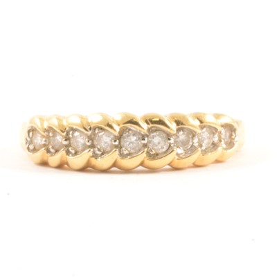 Lot 15 - A diamond half hoop ring.