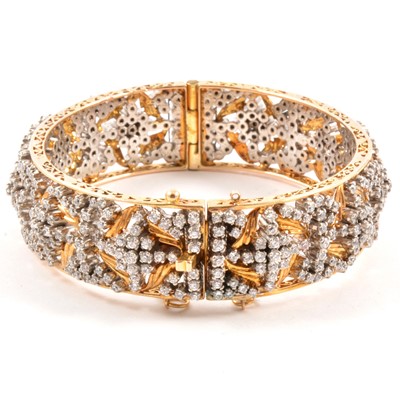 Lot 178 - A yellow metal bangle set with synthetic white stones.