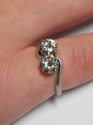 Lot 14 - A diamond two stone crossover ring.