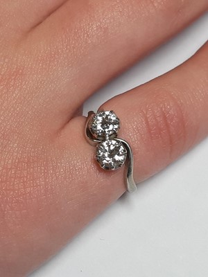 Lot 14 - A diamond two stone crossover ring.