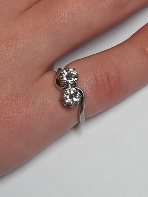 Lot 14 - A diamond two stone crossover ring.