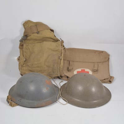 Lot 135 - Two World War II tin helmets, khaki bags.