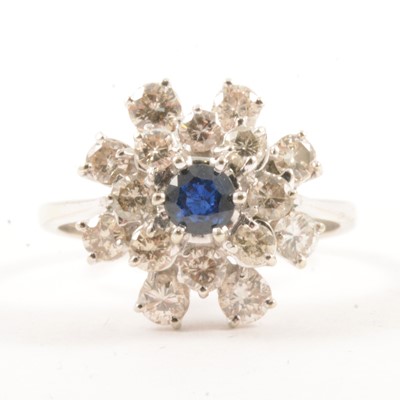 Lot 18 - A sapphire and diamond cluster ring.