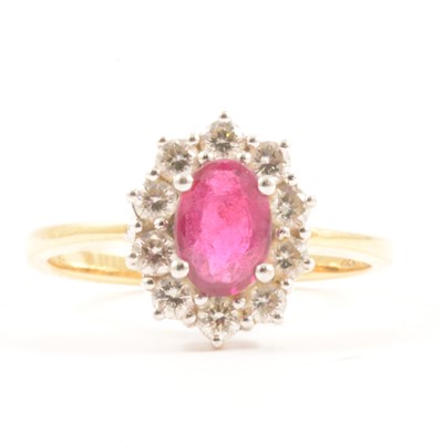 Lot 23 - A ruby and diamond cluster ring.