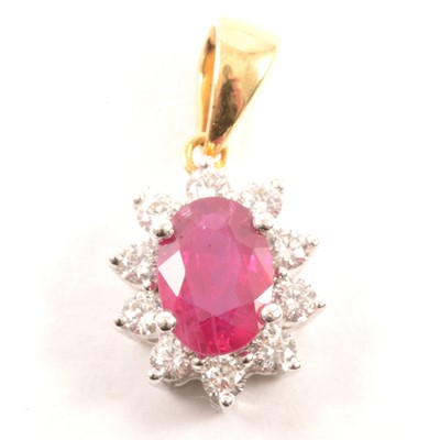 Lot 90 - A ruby and diamond oval cluster pendant.