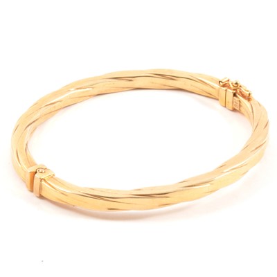 Lot 179 - A 9 carat yellow gold hollow half hinged bangle.