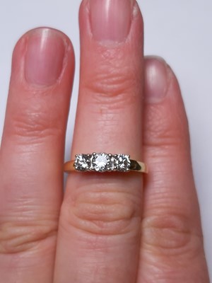 Lot 6 - A diamond three stone ring.