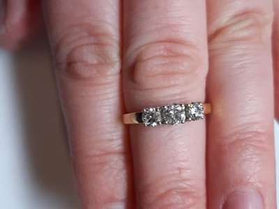 Lot 6 - A diamond three stone ring.