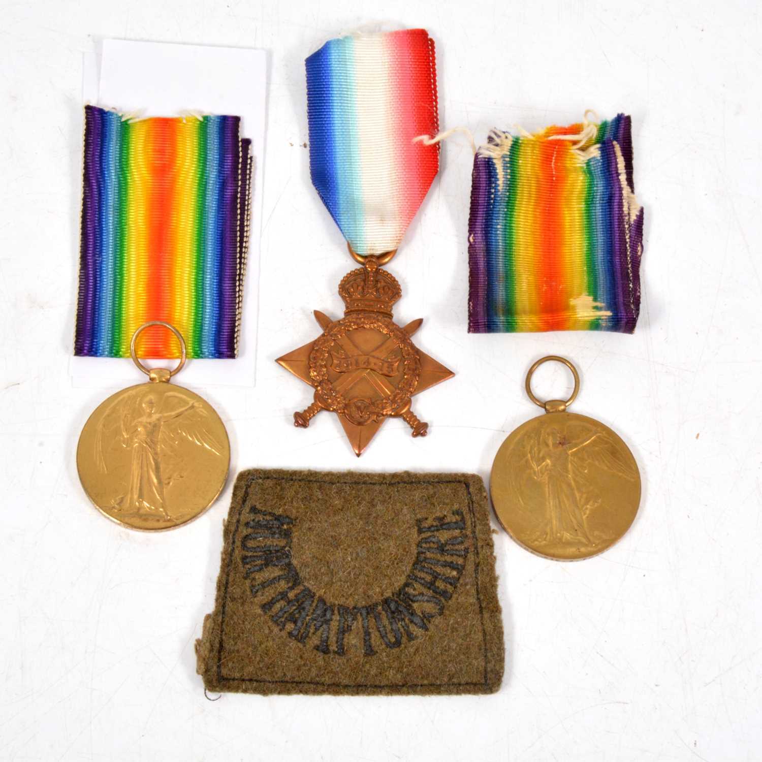 Lot 250 - Medals - Three WW1 medals with ribbons, and a Northamptonshire patch.