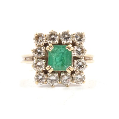 Lot 71 - An emerald and diamond square cluster ring.