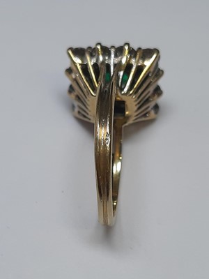 Lot 71 - An emerald and diamond square cluster ring.